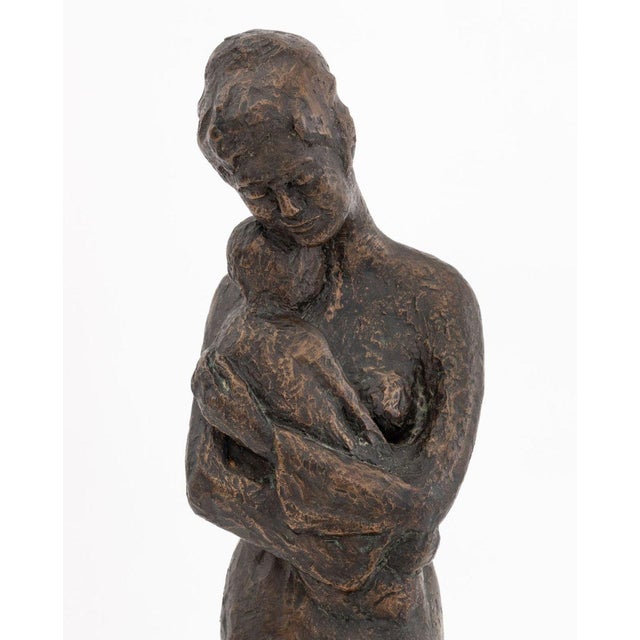 Tanya Poust (American, XX) Mother and Child Patinated Bronze Sculpture, mounted on a white marble base. 18.25" H x 4.25" W...