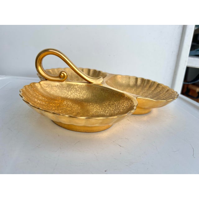 This is a gorgeous divided candy bowl by Wheeling Gold China. It is metallic gold with an intricate embossed floral design...
