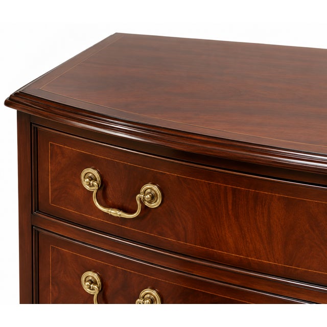 Handsome traditional four-drawer chest featuring richly figured mahogany-toned wood, a gently bowed front and classic...