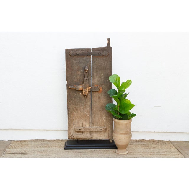 From the Bandiagara escarpment region of central Mali, this two-plank granary door retains its complete, original hand-...