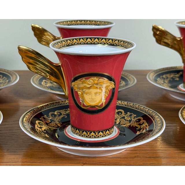 A dramatic and luxurious set of six espresso cups and saucers from the Rosenthal x Versace collaboration, featuring the...