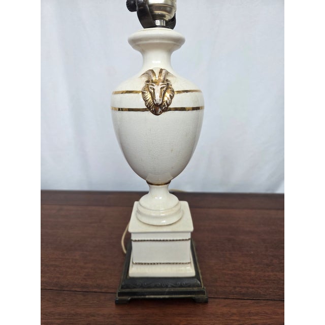 This striking vintage table lamp embodies the timeless elegance of Neoclassical Revival design, blending classical...