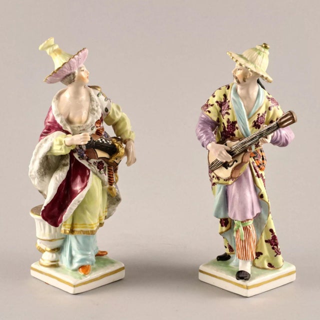 Porcelain pair "Chinese Musicians". Represents a lady and a man in colorful stylized oriental outfits, performing...