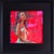 This oil on panel artwork presents a seated figure, bathed in vibrant hues of red and pink that create a dynamic...