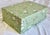 Lillian August Home Green Floral Storage Box. The exterior of the box is covered in a paper that is designed similar to a...