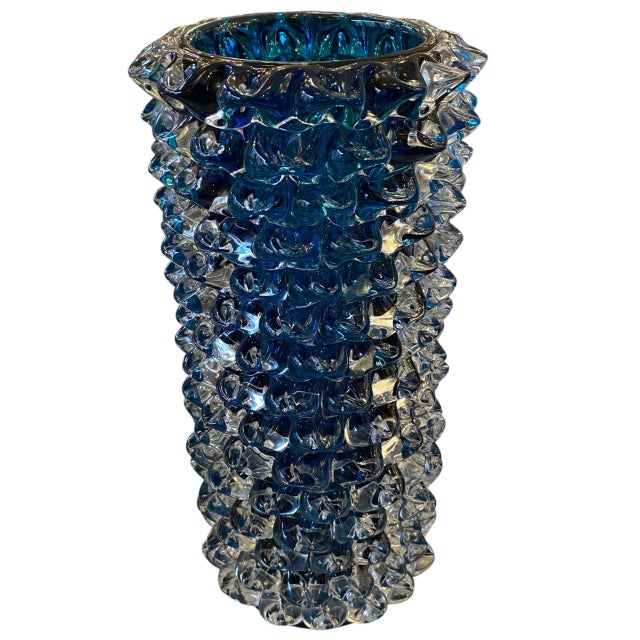 A spectacular Murano vase that stands out for its intense blue color. It is decorated using the rostratum technique, a...