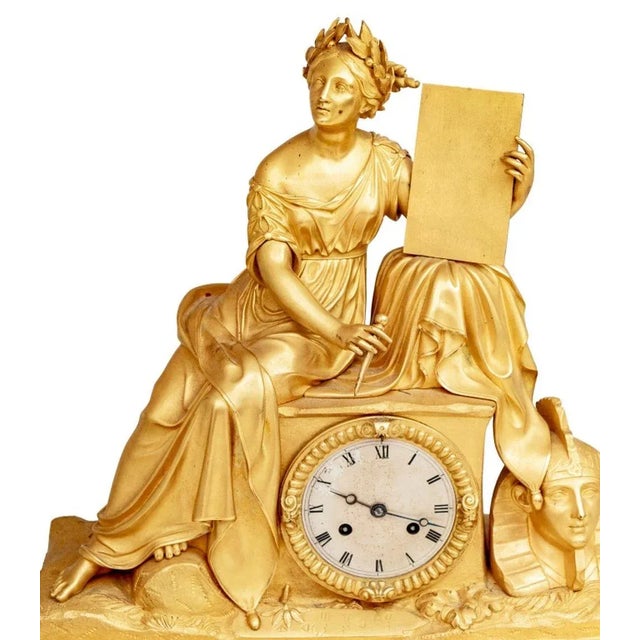 Charles X Gilt Bronze Figural Mantel Clock, circa 1830, the silvered dial with strike on bell movement, surmounted by a...