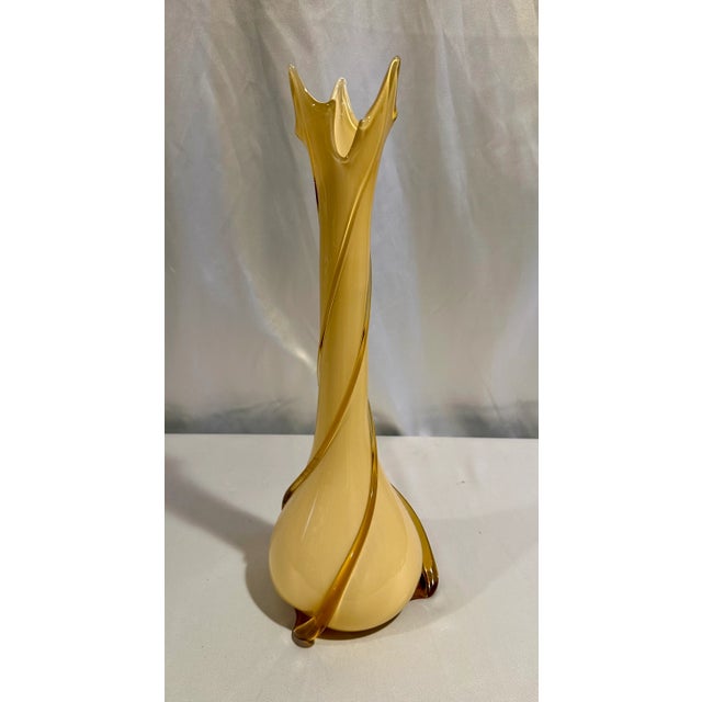A vintage tall Murano Art glass free from vase in a buttery yellow with amber colored pulled swirled accents. 19” h x 6.5”...