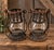 Striking pair of circa 1920s pressed/tinned metal and glass candle lanterns featuring ornate pierced metal galleries,...