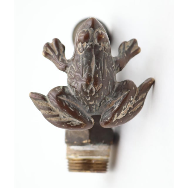 Vintage style outdoor garden spigot made of brass with a patina finish. It features a frog turn handle to open and close...