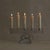 A French crystal candelabra from the 1960s, in the manner of Daum. A molten, rock-like base rises into a linear bar cut to...