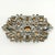 Vintage brooch decorated with clear rhinestones in varying shapes and sizes set in pot metal. A great example of 1930s...