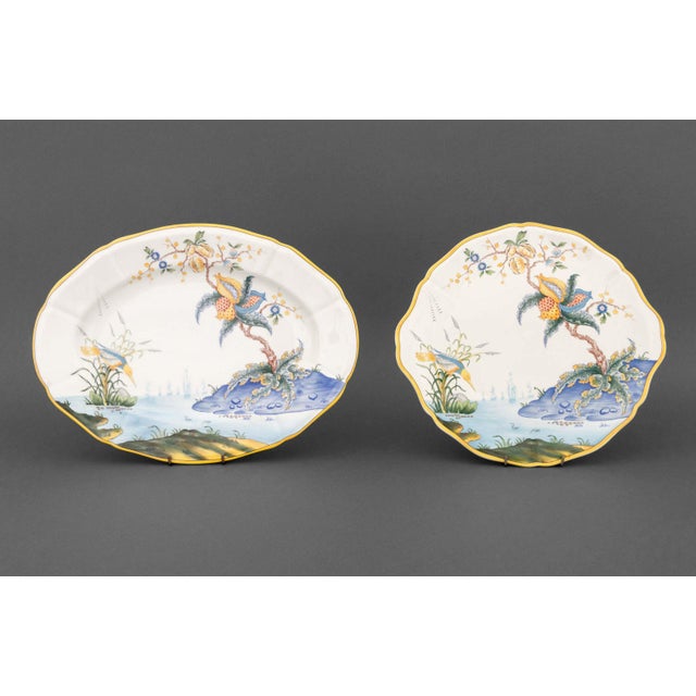 Collection of Four Gien "Caraibes" Faience Tableware Pieces, with bird and river scene, comprising: scalloped rim square...