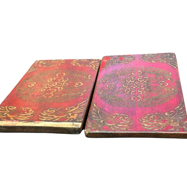 A rare and striking pair of antique Tibetan wooden cabinet doors featuring embossed dragon medallions and auspicious cloud...