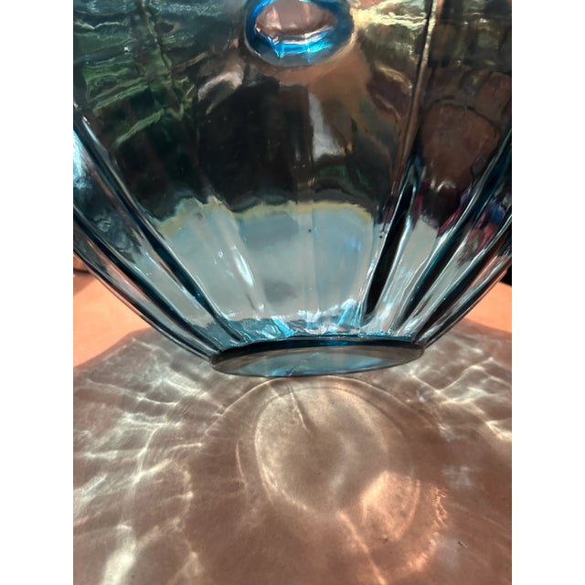 Over Sized Vintage Blue Ribbed Vase. Such a nice pop of color and eye catching piece. Thick heavy semi clear blue glass....
