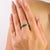 This 925 Sterling Silver band ring showcases a fresh and vibrant emerald gemstone measuring 2.5×2.5 mm with a total weight...