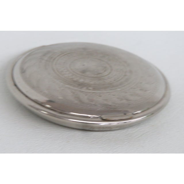 This exquisite rounded Powder Compact / Mirror is made out of silver-tone metal. This compact was made in the U.S.A. by...