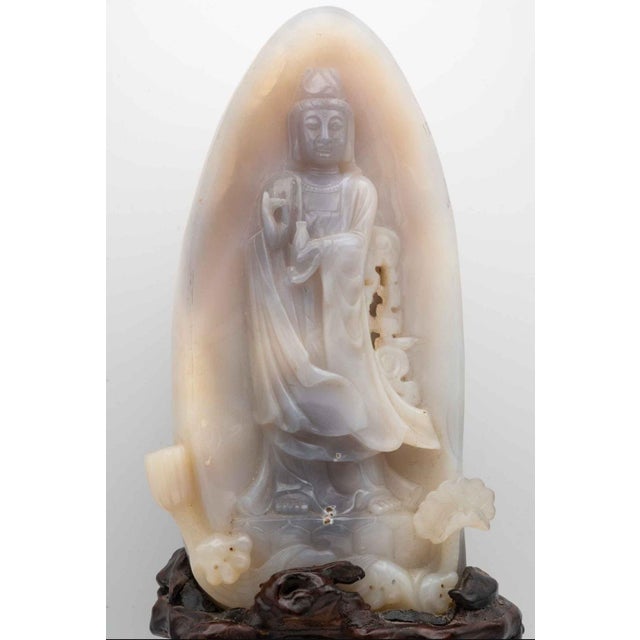 This exquisite hand-carved Chinese sculpture depicts Guanyin, the Bodhisattva of Compassion, intricately rendered in...