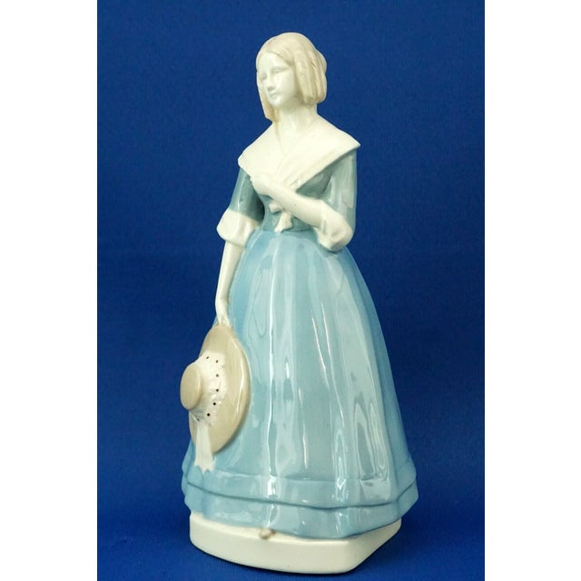 Ceramic cast sculpture, made with kaolin, also known as "soft porcelain," glazed, vitrified, and hand-decorated with an...