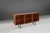 This Belgian 1960s mid‑century teak sideboard embodies the clarity, warmth, and functional elegance that defined postwar...