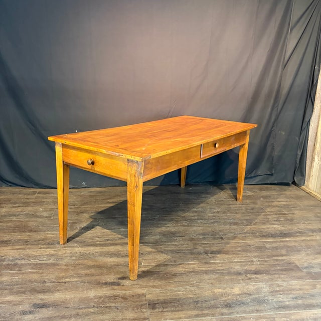 Beautiful French hardwood dining table with a warm honey-toned patina that highlights the natural character of the walnut...
