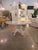 Beautiful 60" round resin dining table featuring a glossy frost white top and a sculptural faux bois driftwood-style...