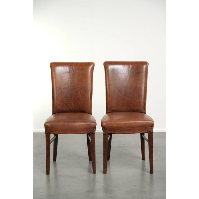 This coveted set of 6 sheepskin dining chairs is crafted in a beautiful cognac color and features a stunning patina. A...