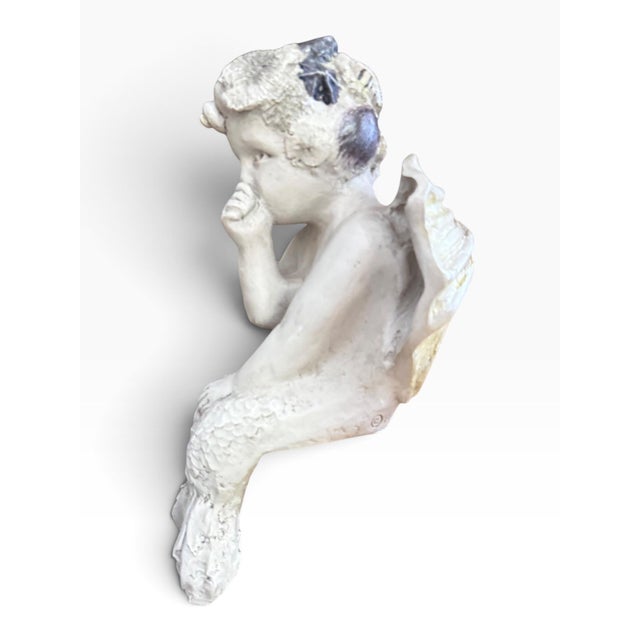 A charming and wonderfully sculptural 1999 R. Shipman Inc. mermaid angel cherub shelf sitter, depicting a winged mermaid...