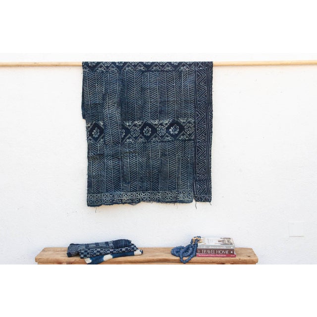 A masterwork of Malian textile heritage featuring deep indigo saturation and symbolic geometric motifs. Originating from...