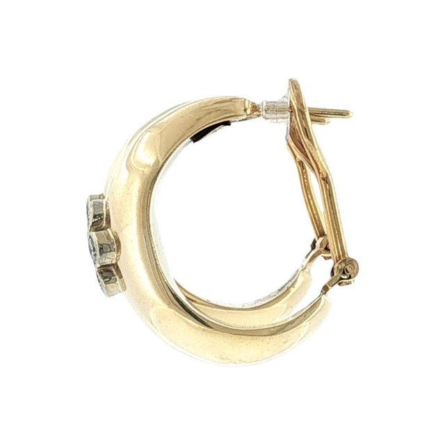 A pair of late 20th-century 14k gold domed hoop earrings featuring brilliant-cut diamonds. The primary stones are white,...