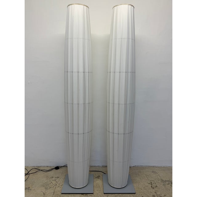 Pair of Colonne floor lamps with inner steel frame, off-white pleated fabric outer shell and steel base by Fabrice Berrux...
