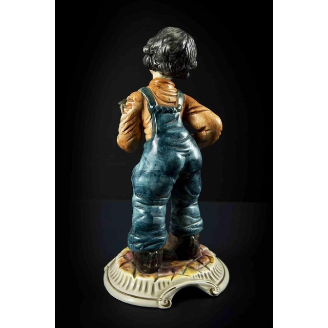 Vintage ceramic child sculpture is an original decorative object realized in the mid-20th century. Made in Italy. Colored...