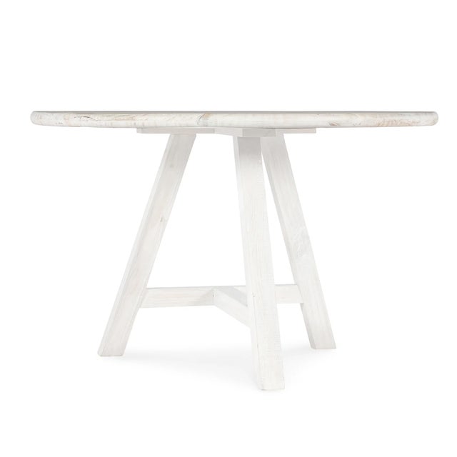 Minimalist round whitewashed dining table.