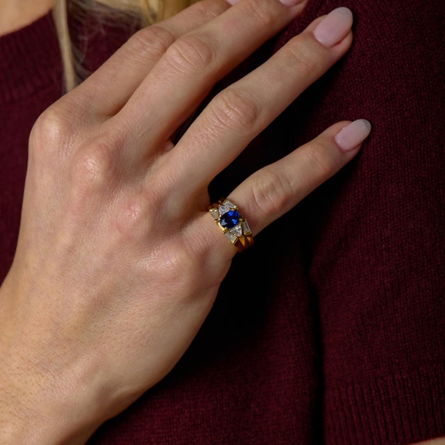 This elegant vintage engagement ring reflects the bold sophistication of 1980s design, anchored by a beautifully...