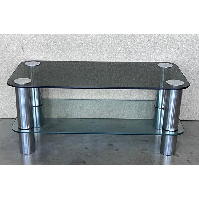 Mid-Century Modern chrome coffee table with smoked level up glass top and clear glass in low shelve. Details Dimensions...