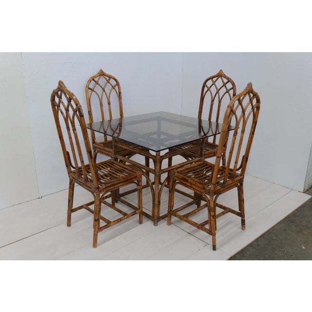 The Mid Century Italian set of four chairs and table from the 1970s, crafted in giunco wood, exudes a rustic charm and...