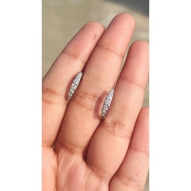 Dainty Diamond Huggie Earrings Set in 18kt Solid White Gold With Shared Prongs - a Pair For Sale - Image 9 of 11