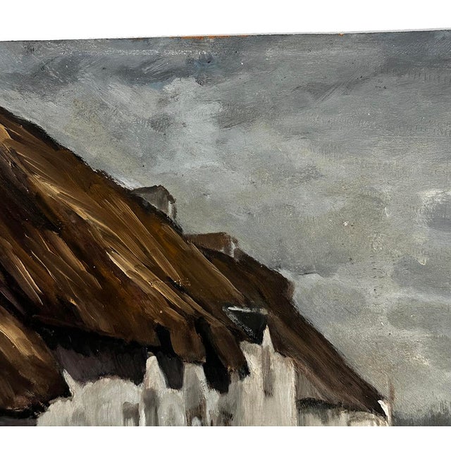 This early 1900's evocative French landscape painting depicts a row of rustic, whitewashed cottages beneath dramatically...