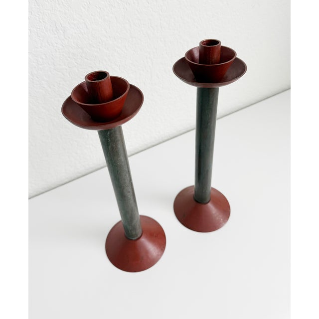 Striking sculptural postmodern metal candlesticks in the style of Memphis design movement. The pair have been hand-painted...