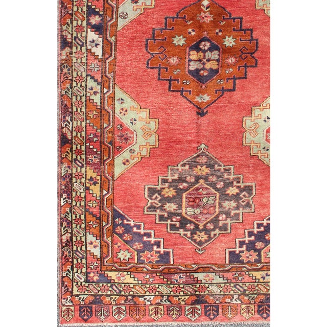 Measures: 4'9 x 9'9. Red field vintage Turkish Oushak rug with vertical geometric medallions. Keivan Woven Arts / rug...