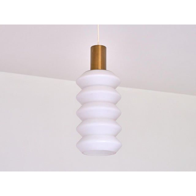 This rare pair of sculptural pendant lights was produced in Sweden in the 1950s. The design is defined by the striking...