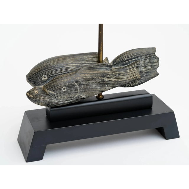 Pair of 1940s cerused fish sculptures on ebonized wood raised platform bases. Lamp shades not included.