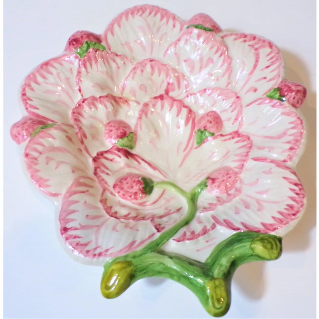 This is a beautiful Majolica dish made in Portugal. This is pink with a white background and wines of small sweet...