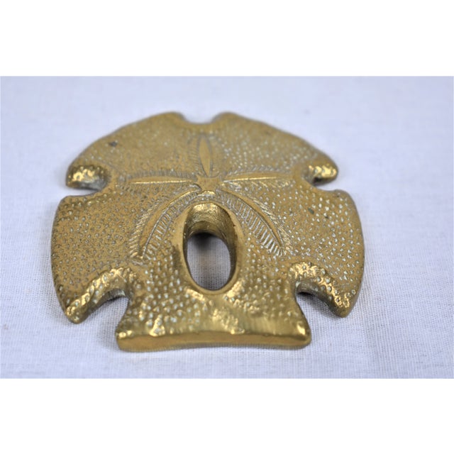 Vintage brass sand dollar paper weight. Nicely detailed and heavy enough to hold down a stack of papers. This is a pre-...