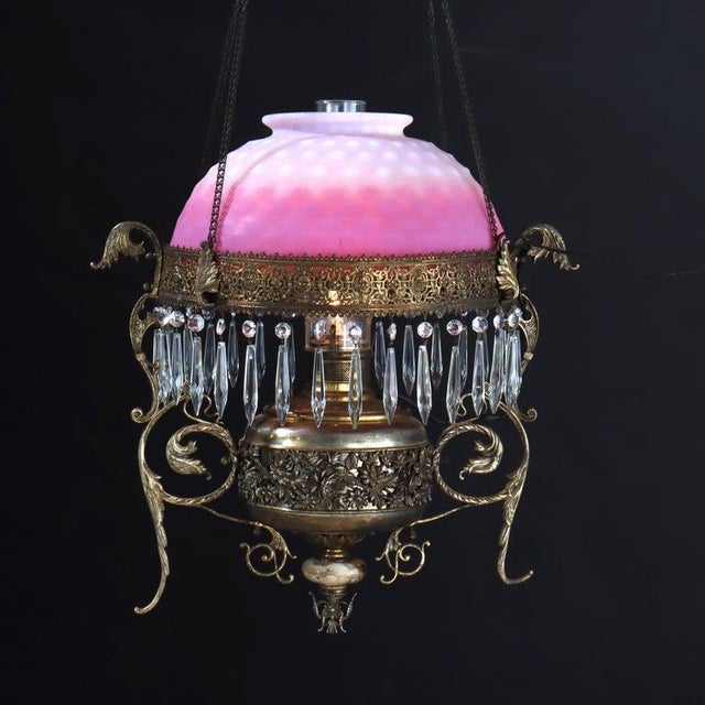 A Victorian hanging chandelier, crafted circa 1880 from a combination of brass and bronze, features a distinctive...