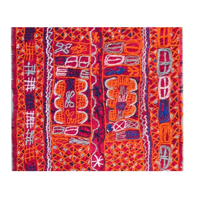 A striking late 20th century Iraqi handwoven crimson wool panel with all-over embroidered geometric patterns stitched in...