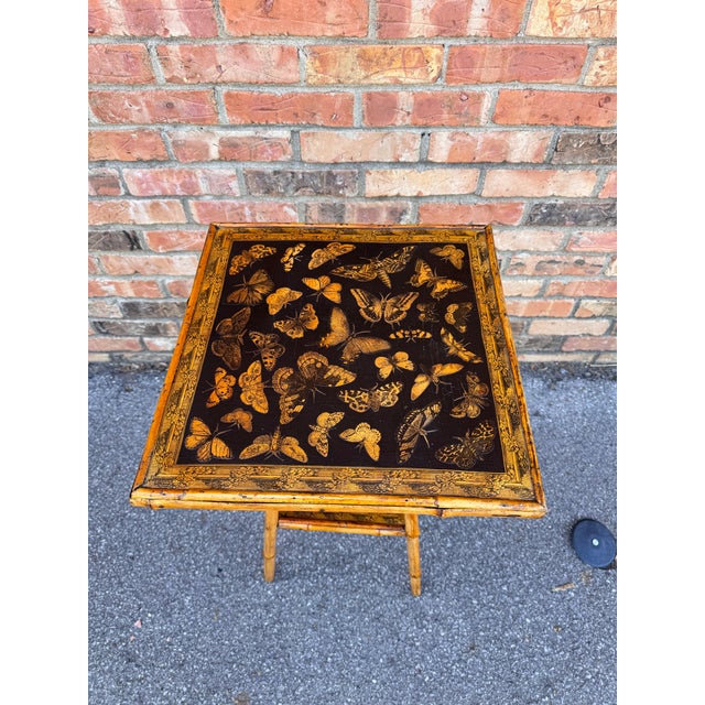 This 19th Century English Bamboo Side table features a delightful variety of butterflies decoupaged onto the top and lower...