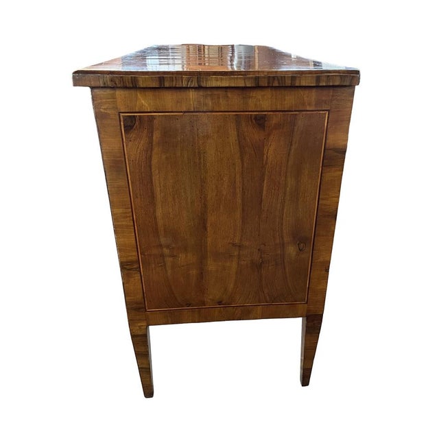 Neoclassical chest of drawers hand-made in Italy in the late 1700s using walnut and decorated with walnut veneer. The...