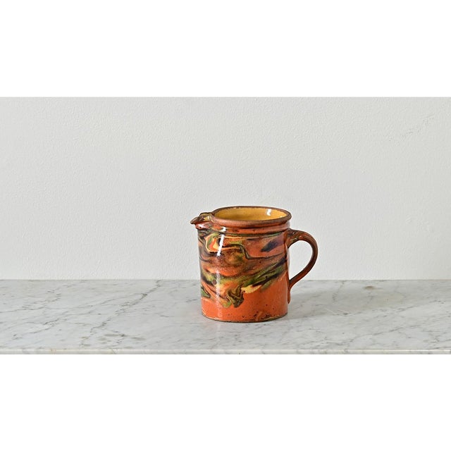 This 19th century jaspé ware French pitcher from the region of Savoie makes an exciting vase or stand alone décor item of...