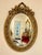 Elegant Italian style vertical oval wall mirror featuring an ornate gold leaf frame beautifully enhanced with decorative...